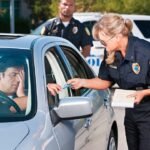 Police officer inspecting vehicle during traffic stop